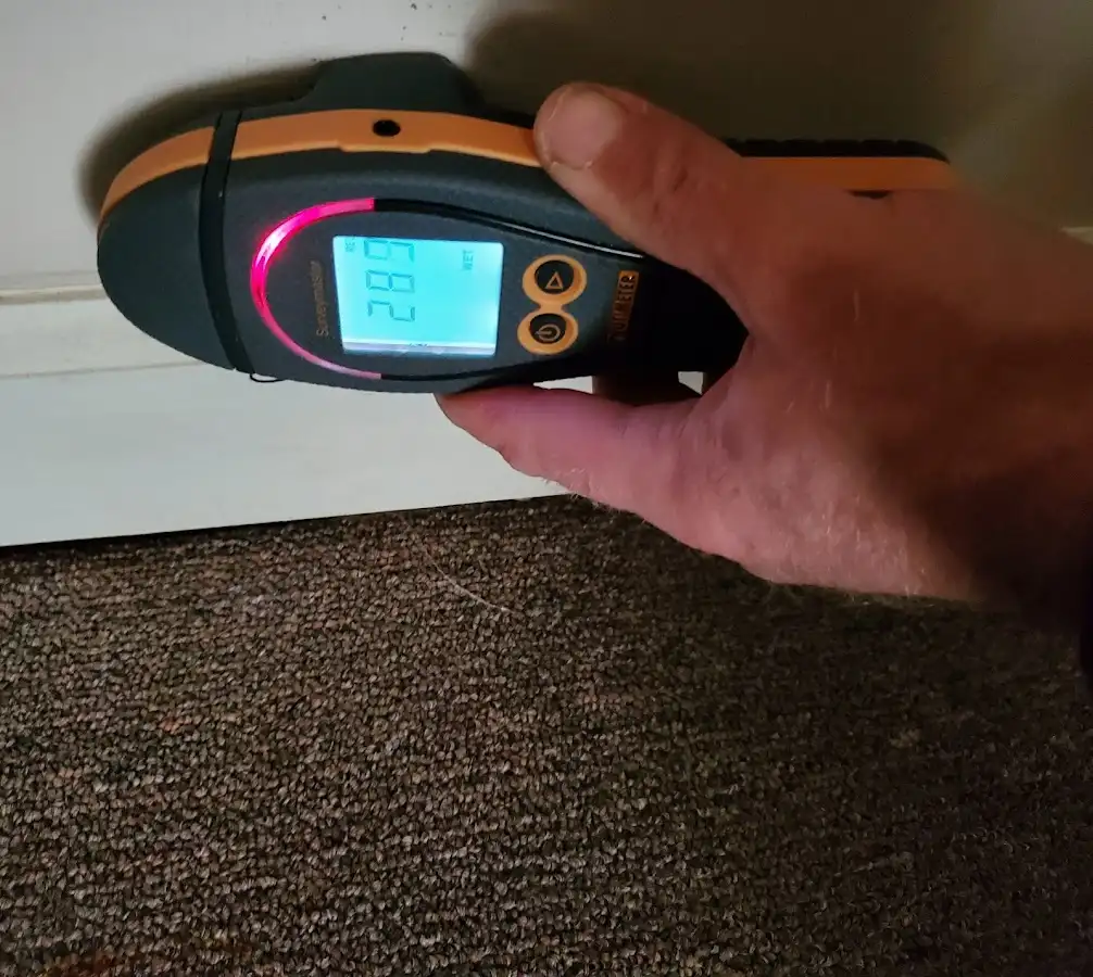 Moisture detection at baseboard during Storm Damage Restoration in Mayflower Village